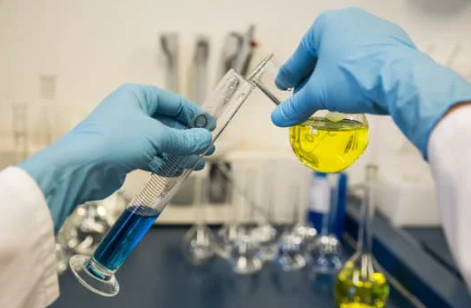 Laboratory technician analyzing oil samples using advanced spectroscopy equipment